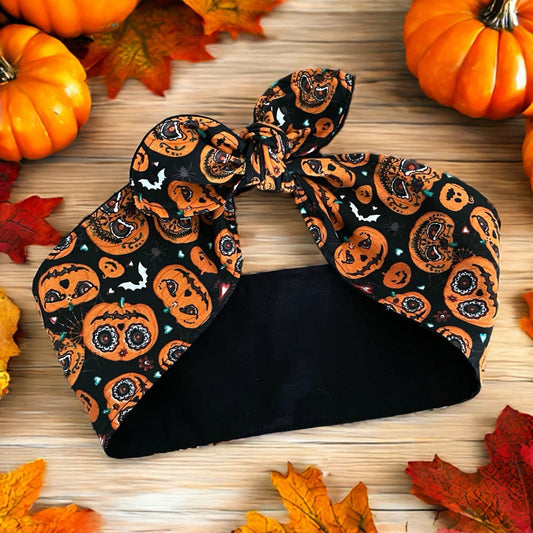 Haarband in schwarz mit orangen Kürbisfratzen